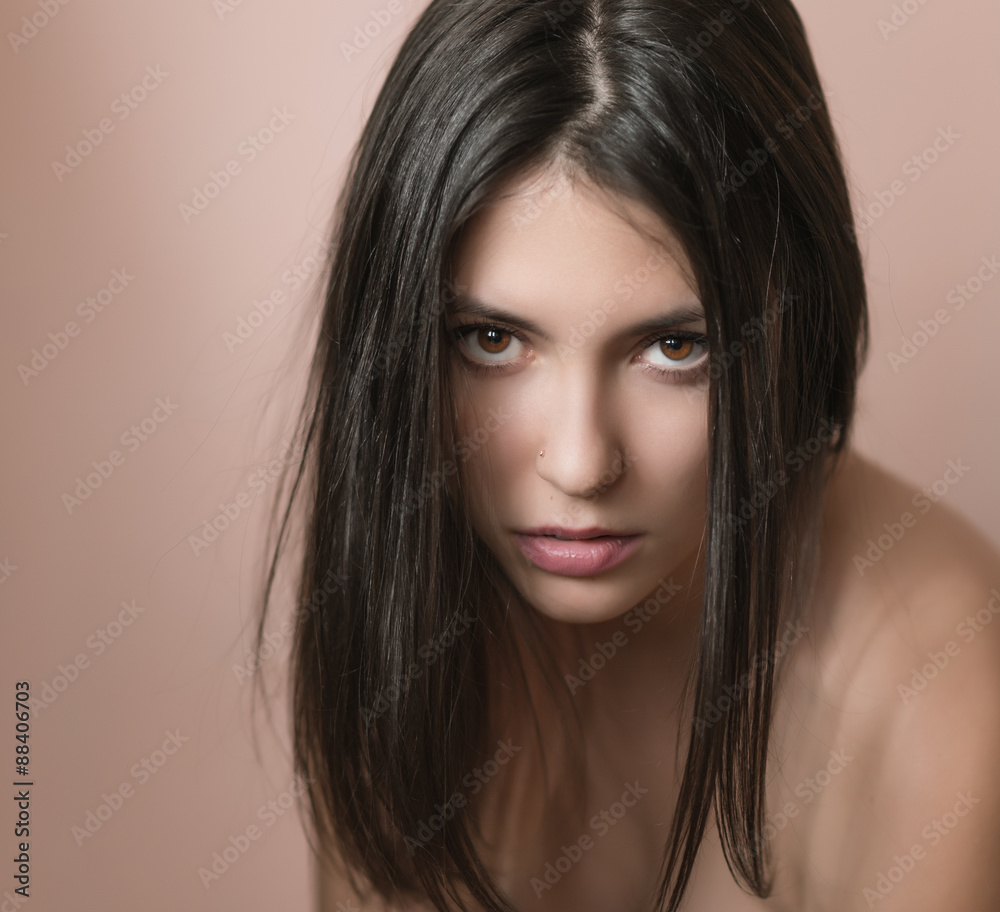 Naklejka premium Portrait of a beautiful young brunette. Selective soft focus.