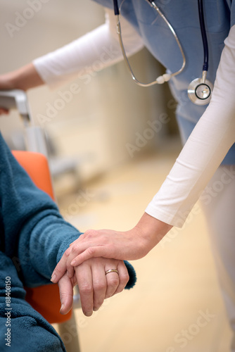 Nurse hold senior's hand