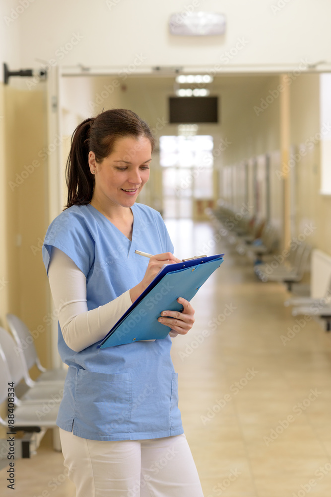 Doctor in hospital writes in folder Doctor in hospital writes in folder