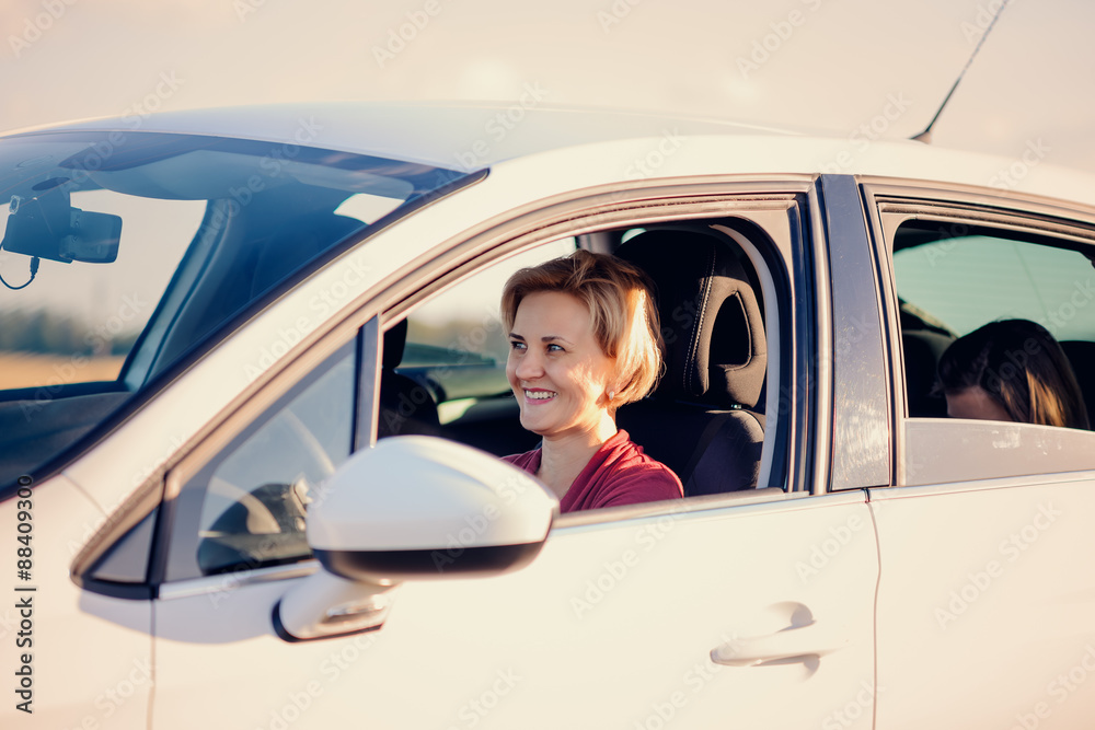 Smiling blond woman driving a car Smiling blond woman driving a car