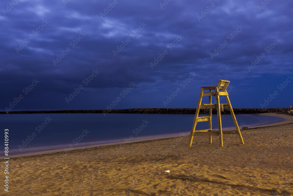 High wooden lifesaver chair on tropical sandy deserted beach night shoot High wooden lifesaver chair on tropical sandy deserted beach night shoot