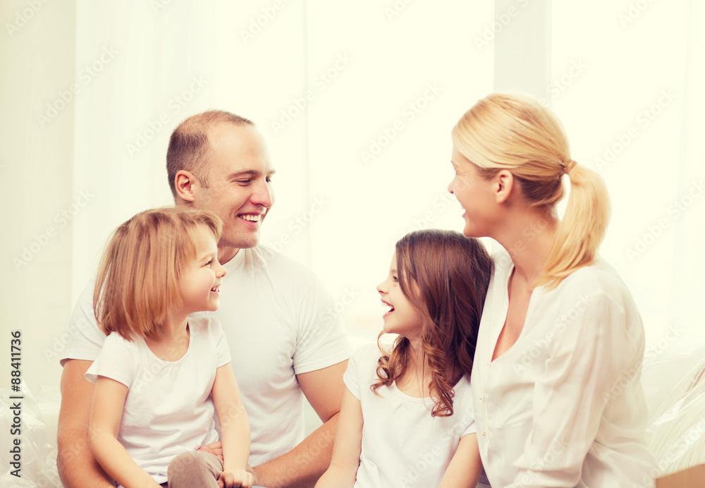 smiling family with two little girls at home smiling family with two little girls at home