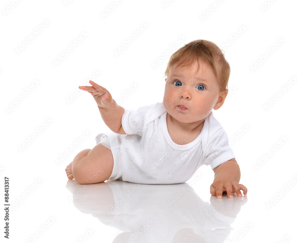 Infant child baby girl lying surprised with hand pointing Infant child baby girl lying surprised with hand pointing