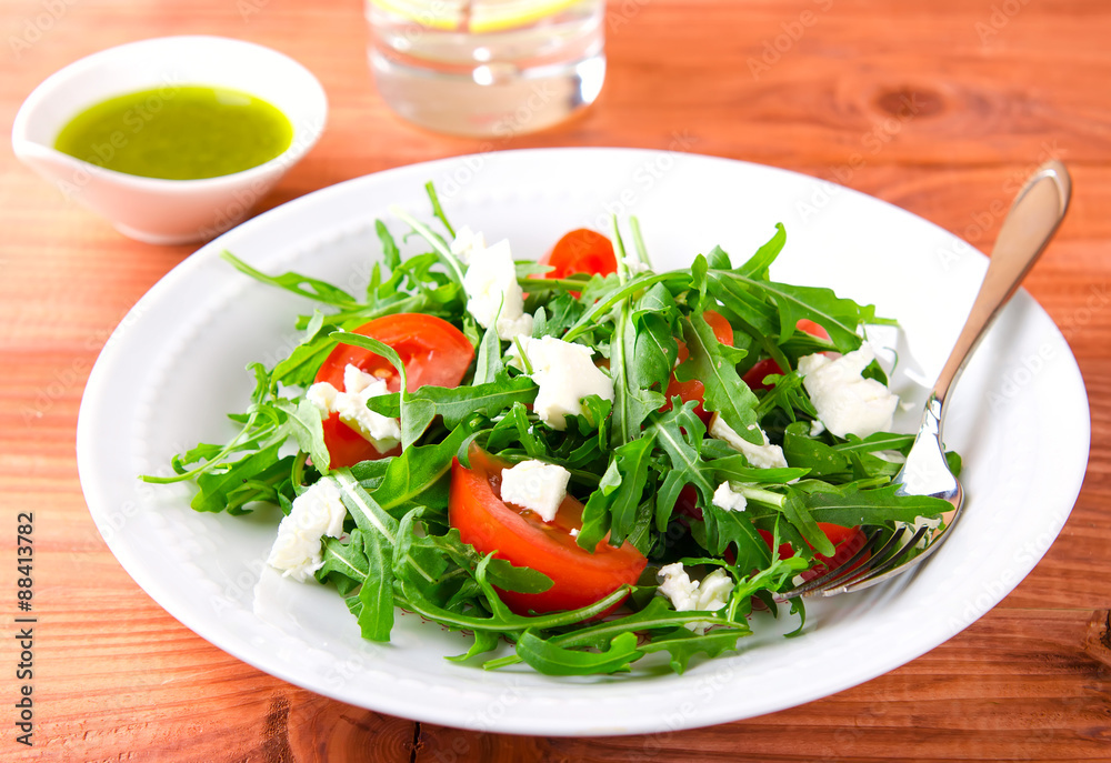 Green salad with arugula, tomatoes and feta cheese