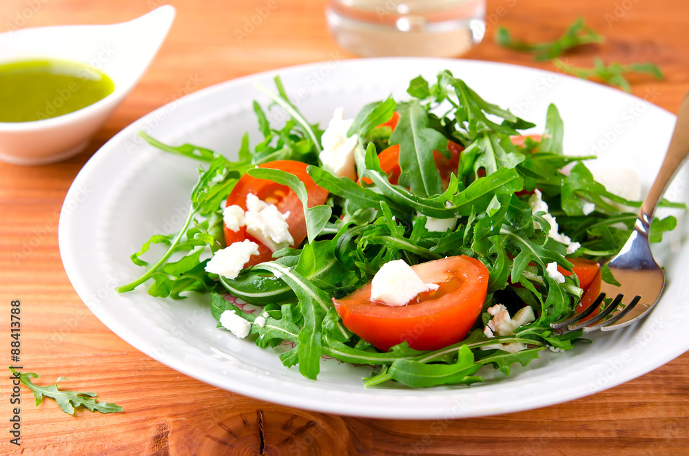 Green salad with arugula, tomatoes and feta cheese Green salad with arugula, tomatoes and feta cheese