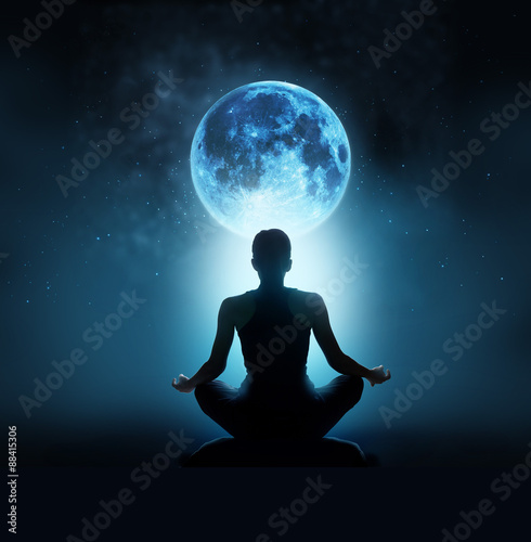 Abstract woman are meditating at blue full moon with star in dark background