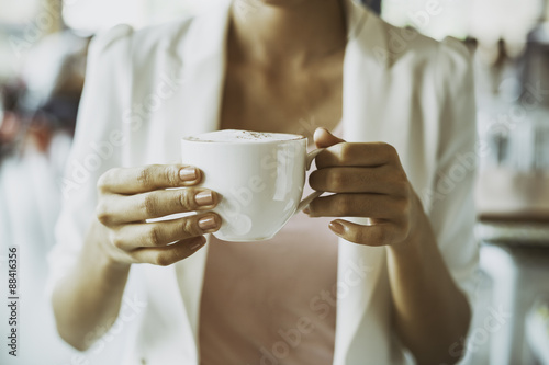 close up of businesswoman holding a cup of coffee