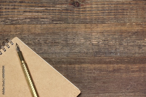 Notepad With Real Gold Fountain Pen On The Old Rough Wooden Table Background