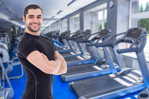 happy handsome bearded arabic man in gym