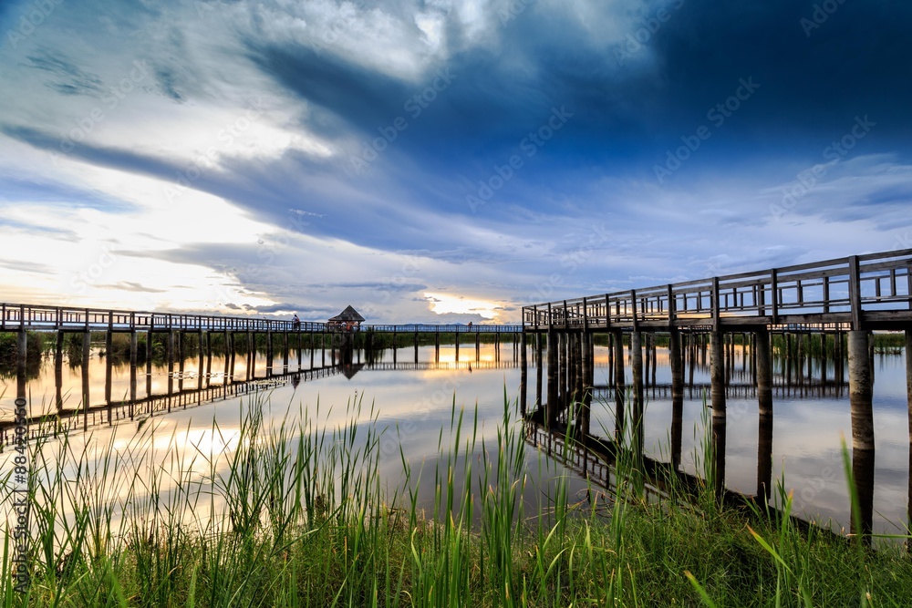 Fototapeta premium Wooden bridge cross around marsh in sunset time at Sam Roi Yot National Park,Thailand