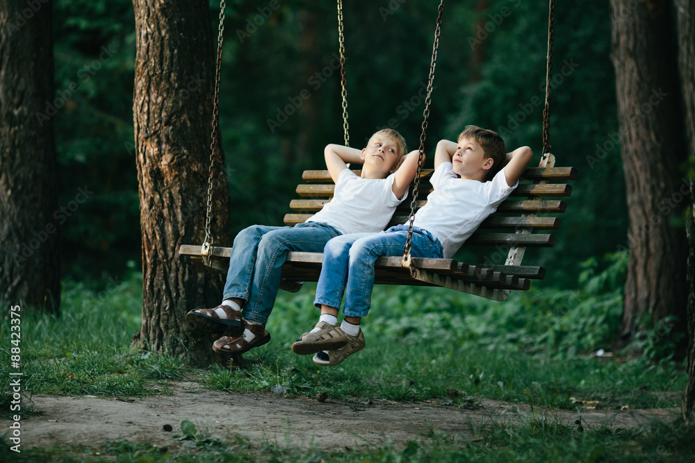 little boys dreaming on swing