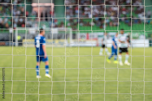 Football net during a football mach. Focus on the net