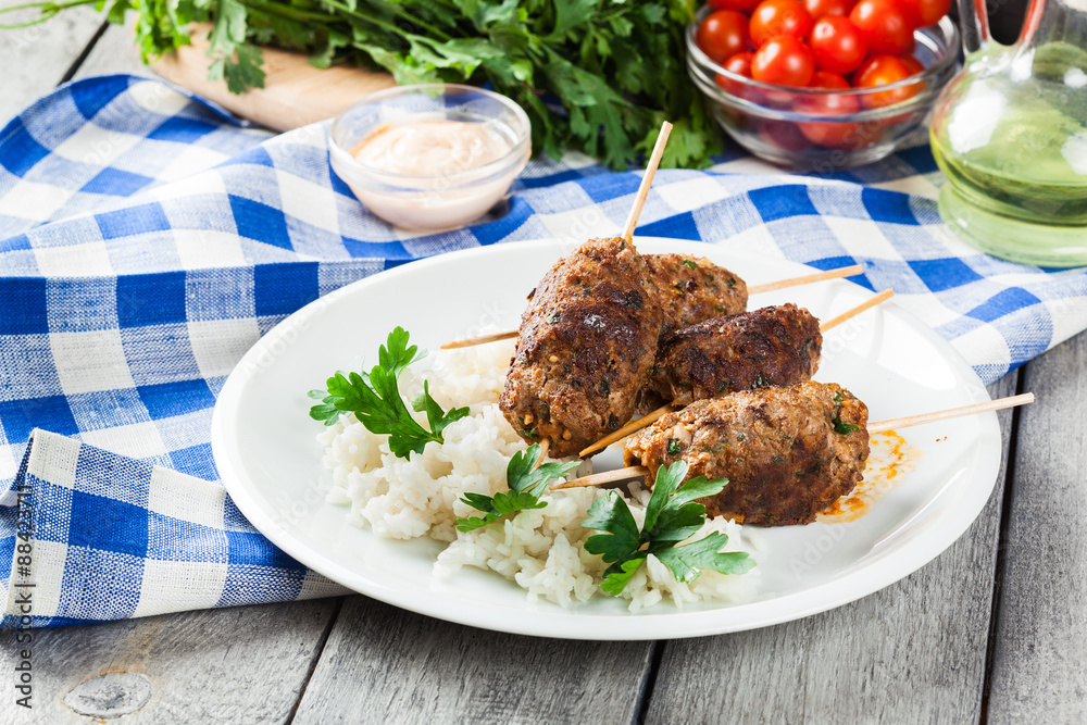 Barbecued kofta with rice on a plate Barbecued kofta with rice on a plate