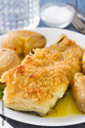 fried fish with potato and oil on dish