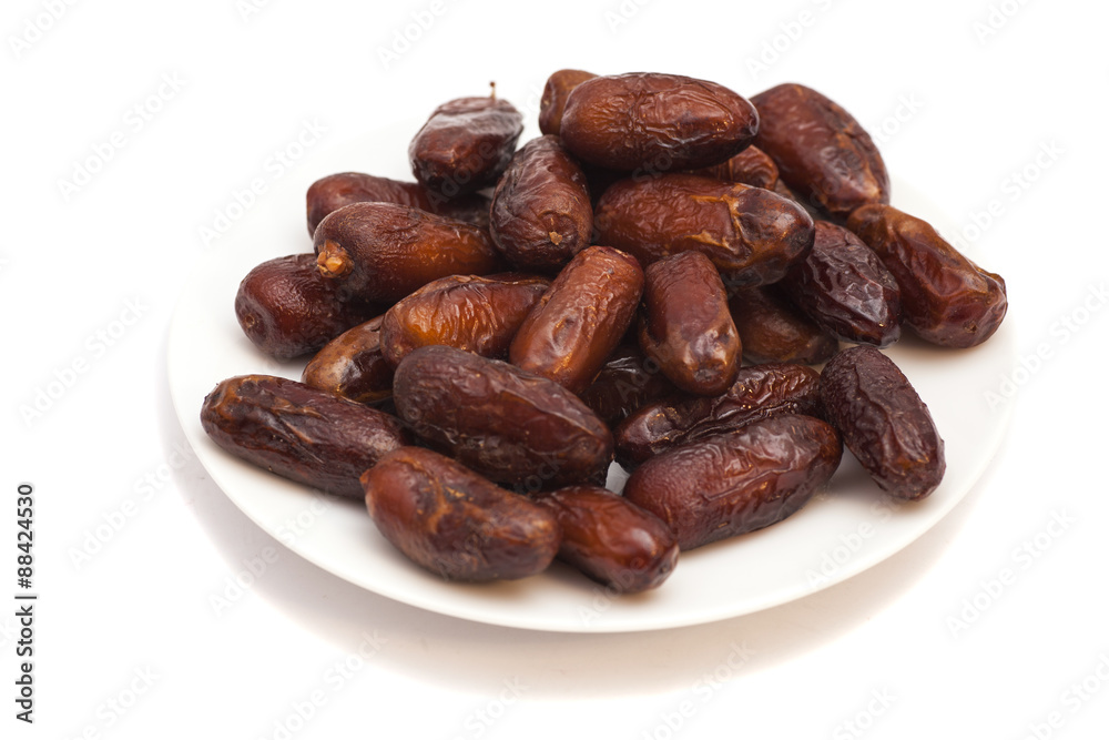Fresh dates on white plate isolated on white background Fresh dates on white plate isolated on white background
