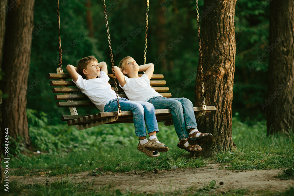 little boys dreaming on swing