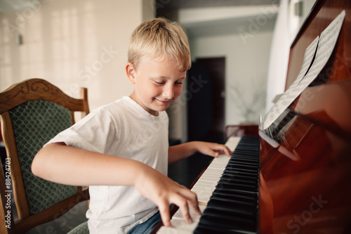 little happy boy plays piano