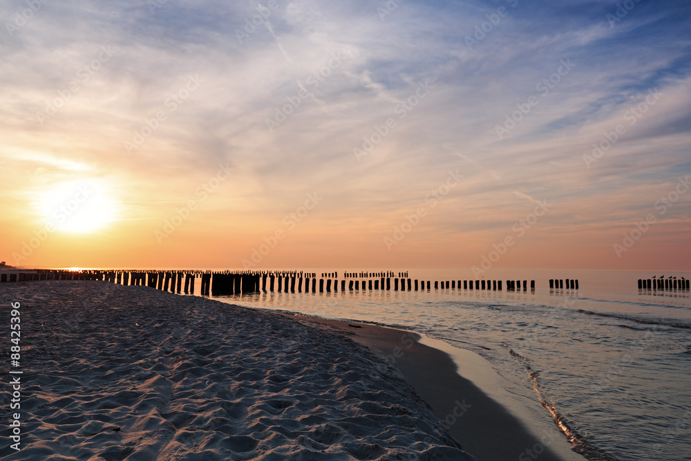 Sunset and breakwaters on the Baltic Sea. Long exposure