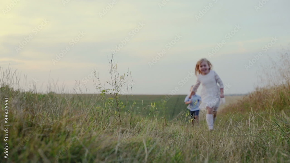 Slow Motion: Happy children running on field road Slow Motion: Happy children running on field road