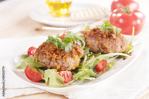 tasty chops with arugula and tomato 