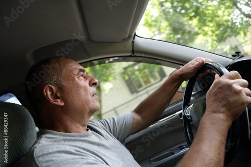 Senior man driving a car © Arkady Chubykin