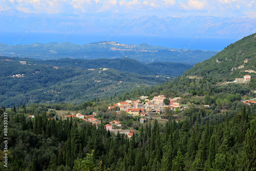 View of the village in a mountain valley. Mountain view and sea view. Ionian sea and Paleokastritsa