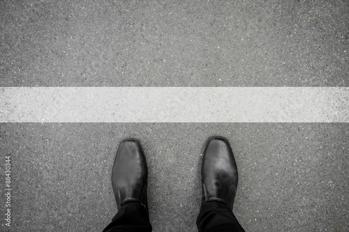Shoes standing in front of white line