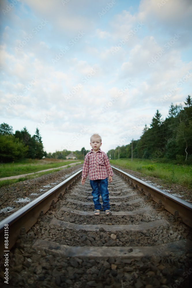 boy playing on the railroad