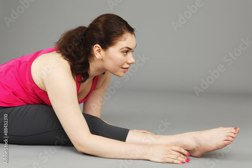 Fototapeta Naklejka Na Ścianę i Meble -  A young woman stretching.