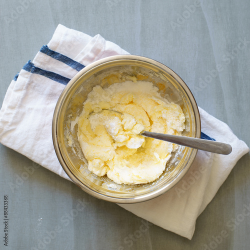 Softened butter being mixed with sugar and powdered sugar to make pate brisee photo