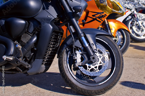Image of different motorcycles standing beside