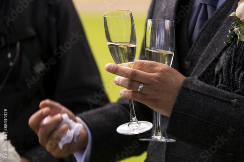 Man holding two champagne glasses