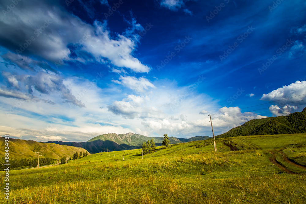 clouds and green meadows in hills  mountains of  Altai