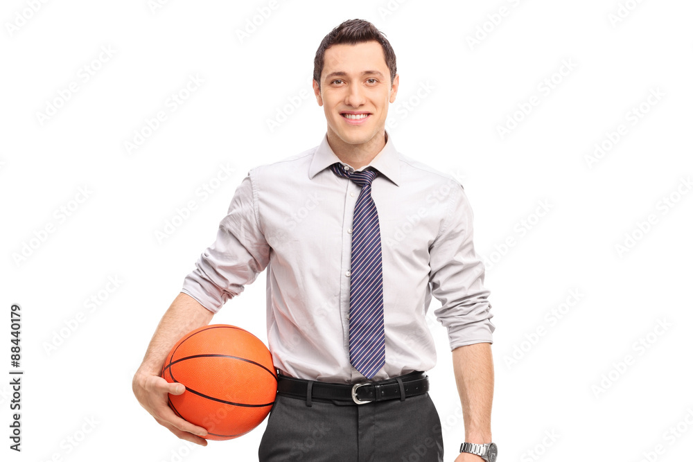 Naklejka premium Handsome businessman holding a basketball