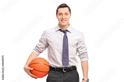 Handsome businessman holding a basketball