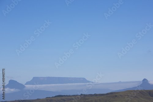 White clouds over the mountains with clear blue sky