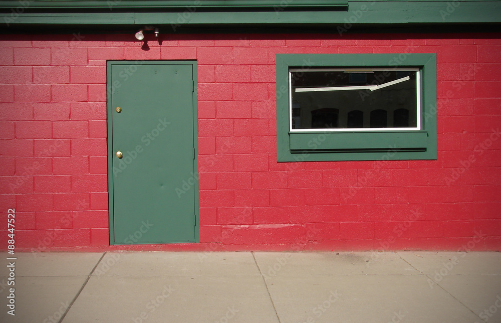 modern red wall with green door and window