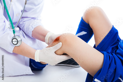 Doctor checking knee injury athlete  on white background. Studio