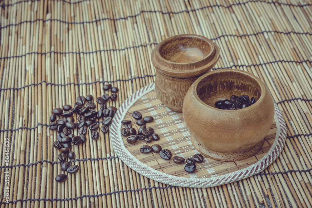 Coffee beans and coffee cup set on bamboo wooden background.Phot Coffee beans and coffee cup set on bamboo wooden background.Phot