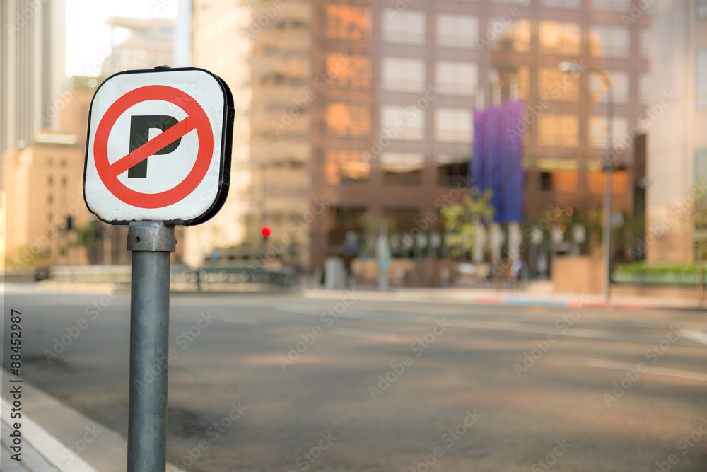 No Parking sign bokeh blurred blurry background urban city business district buildings downtown