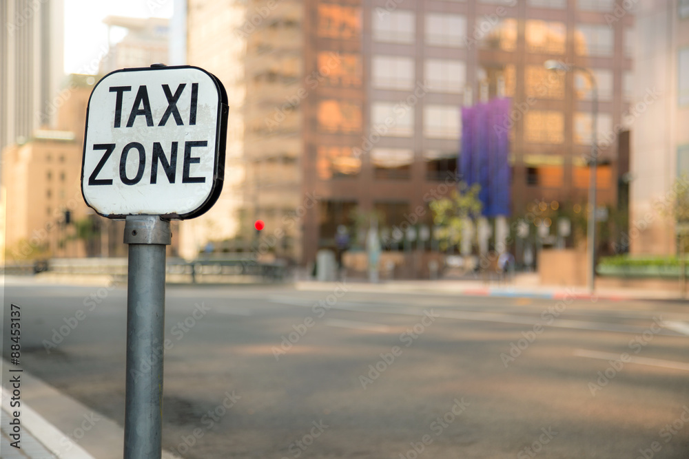 Taxi zone sign bokeh blurred blurry background urban city business district buildings downtown Taxi zone sign bokeh blurred blurry background urban city business district buildings downtown