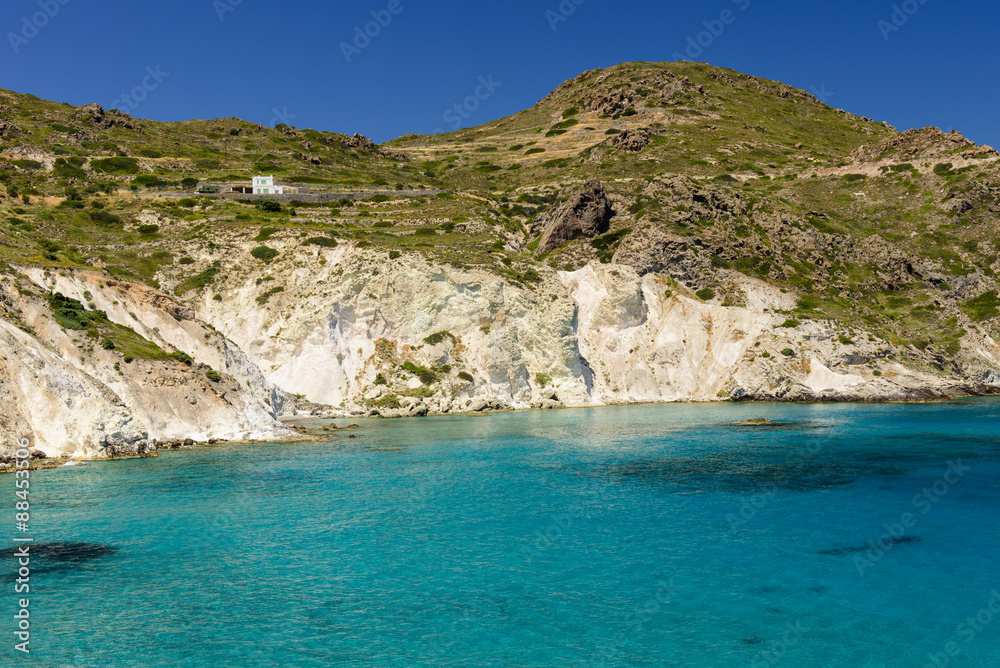 Beautiful coast - azure water and high mountains, Mandrakia village, Milos island, Greece.