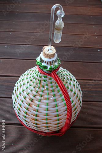Braided carboy with homemade fruit wine