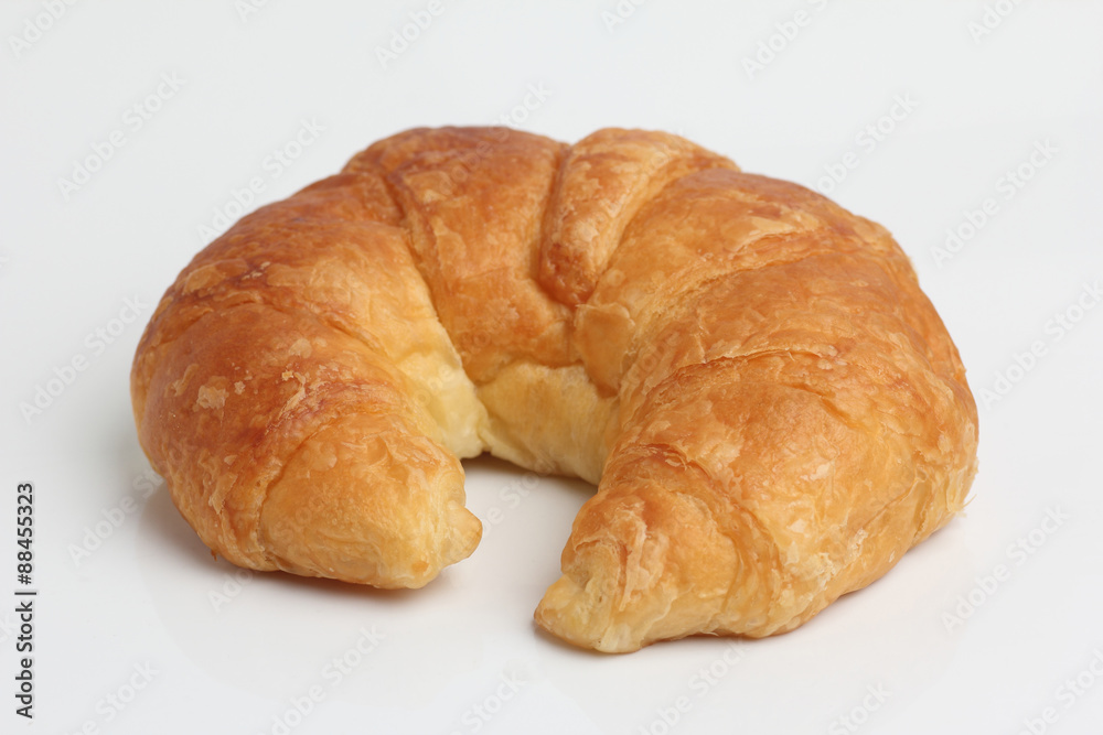 one brown glod croissant isolated