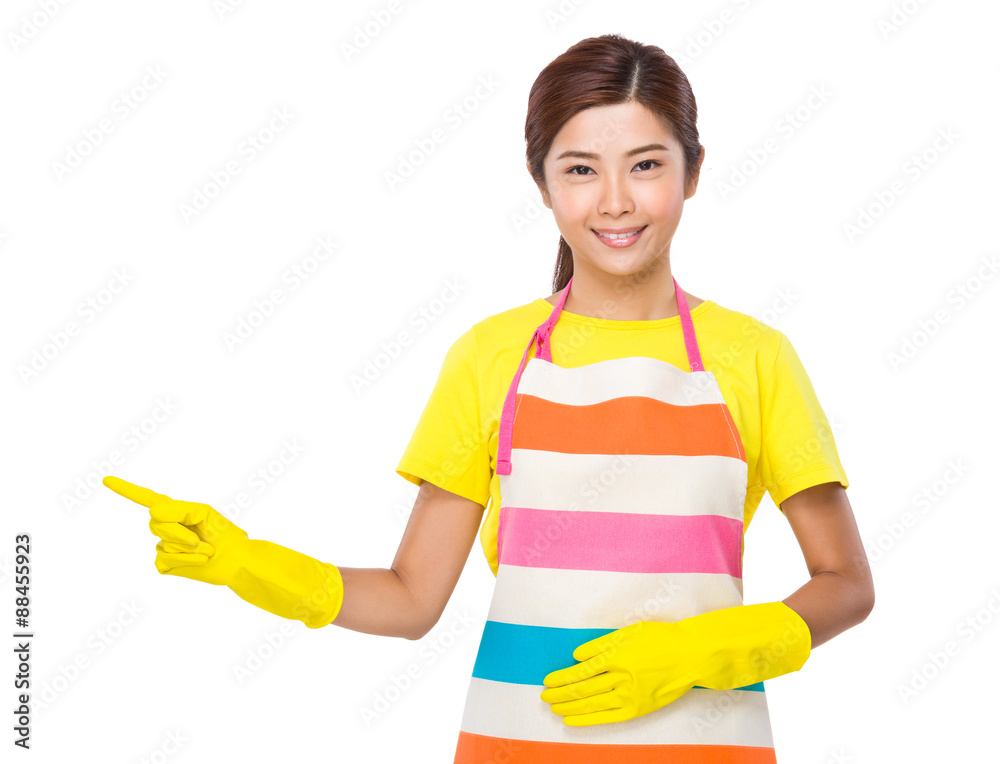 Young housewife with rubber gloves and finger point aside Young housewife with rubber gloves and finger point aside