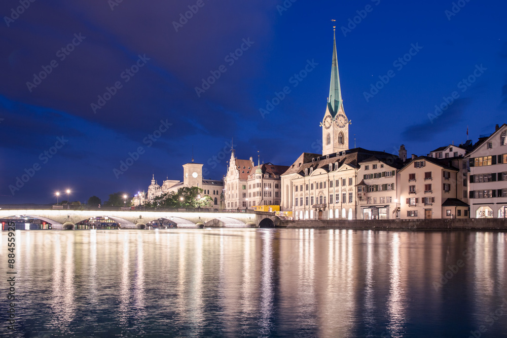 Limmat riverside with famous church and clock tower, Zurich