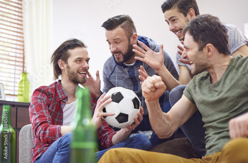 Four best friends talking about soccer match