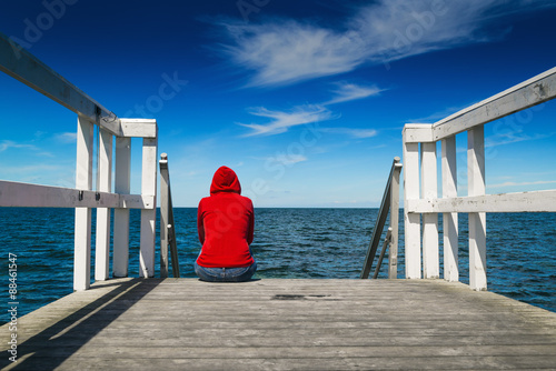 Alone Woman in Red Shirt at the Edge of Pier