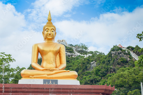 This is Gold Buddha statue in the asian temple  With sky background.