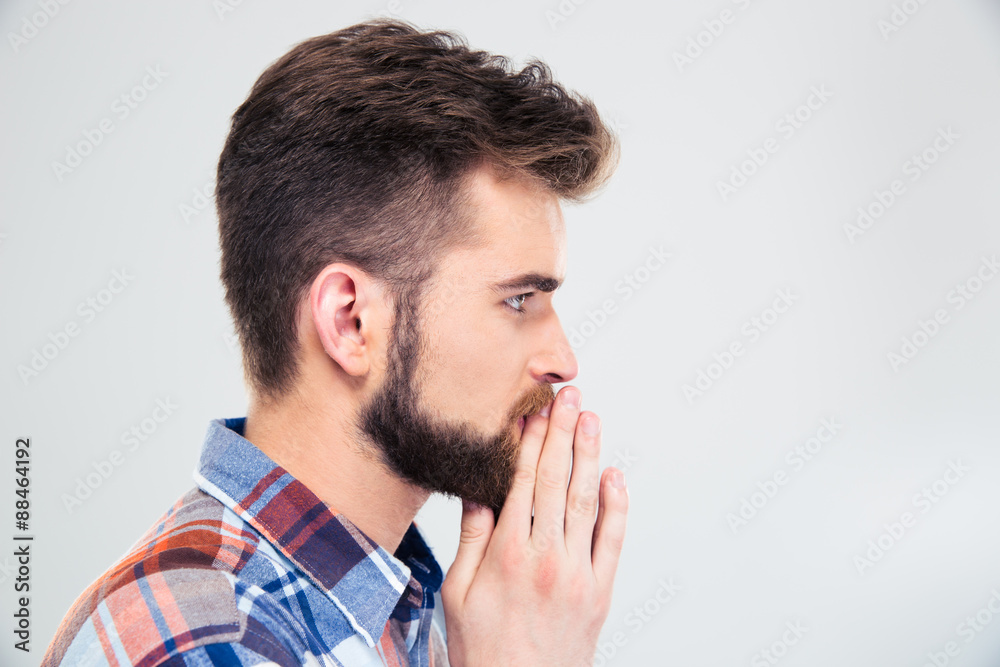 Side view protrait of a casual man praying Side view protrait of a casual man praying